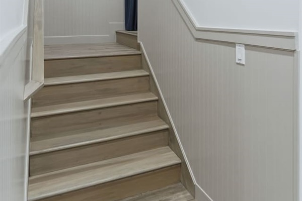 Bright stairway with modern finishes leading to a cozy and inviting upper level