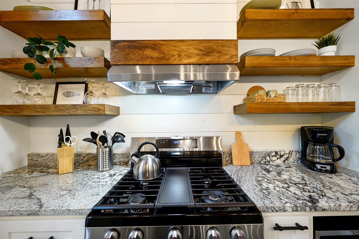 Enjoy a fully equipped space with a gas stove, Keurig, drip coffee maker, cookware, wine glasses, utensils, and everything needed for slow breakfasts and cozy cabin dinners.