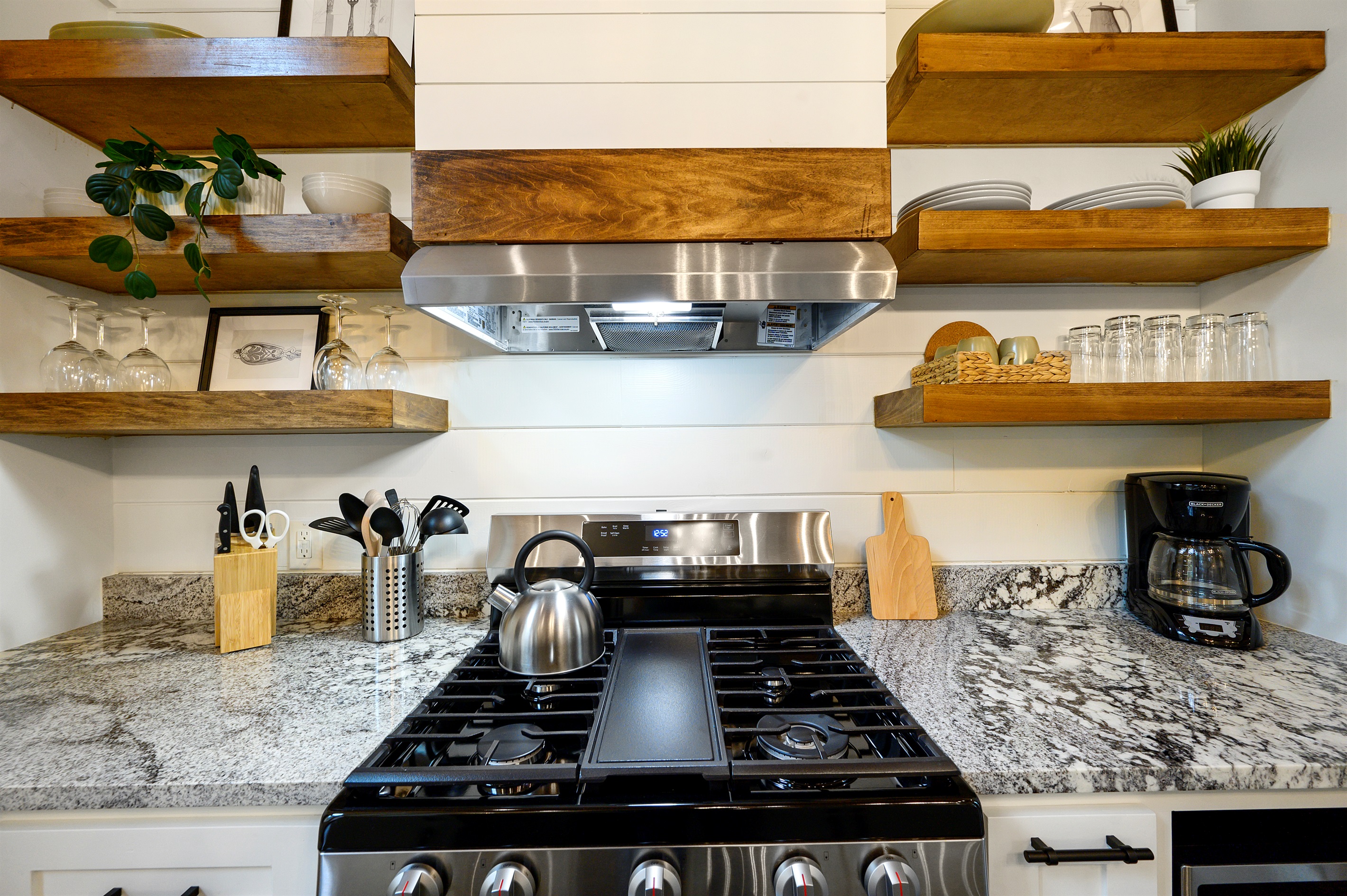 Enjoy a fully equipped space with a gas stove, Keurig, drip coffee maker, cookware, wine glasses, utensils, and everything needed for slow breakfasts and cozy cabin dinners.