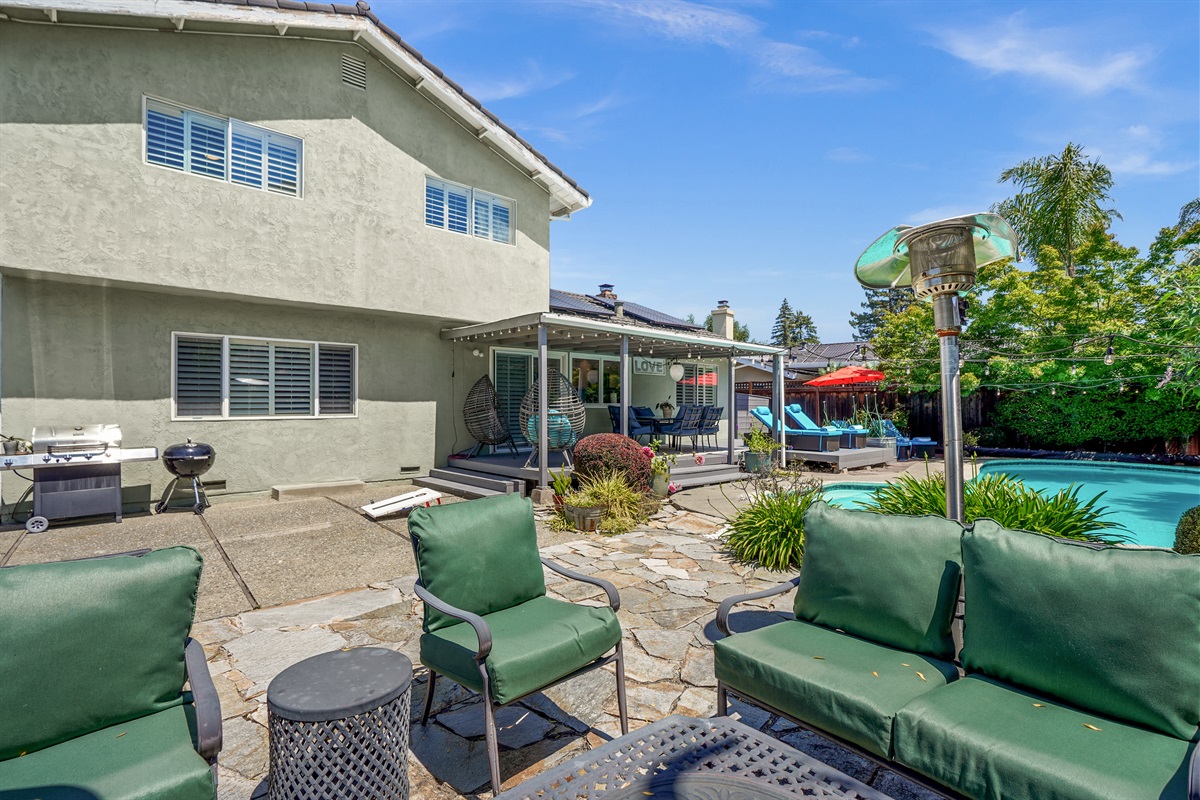 Private backyard retreat with a sparkling pool, outdoor seating, and space to relax and enjoy Napa Valley’s beautiful weather.