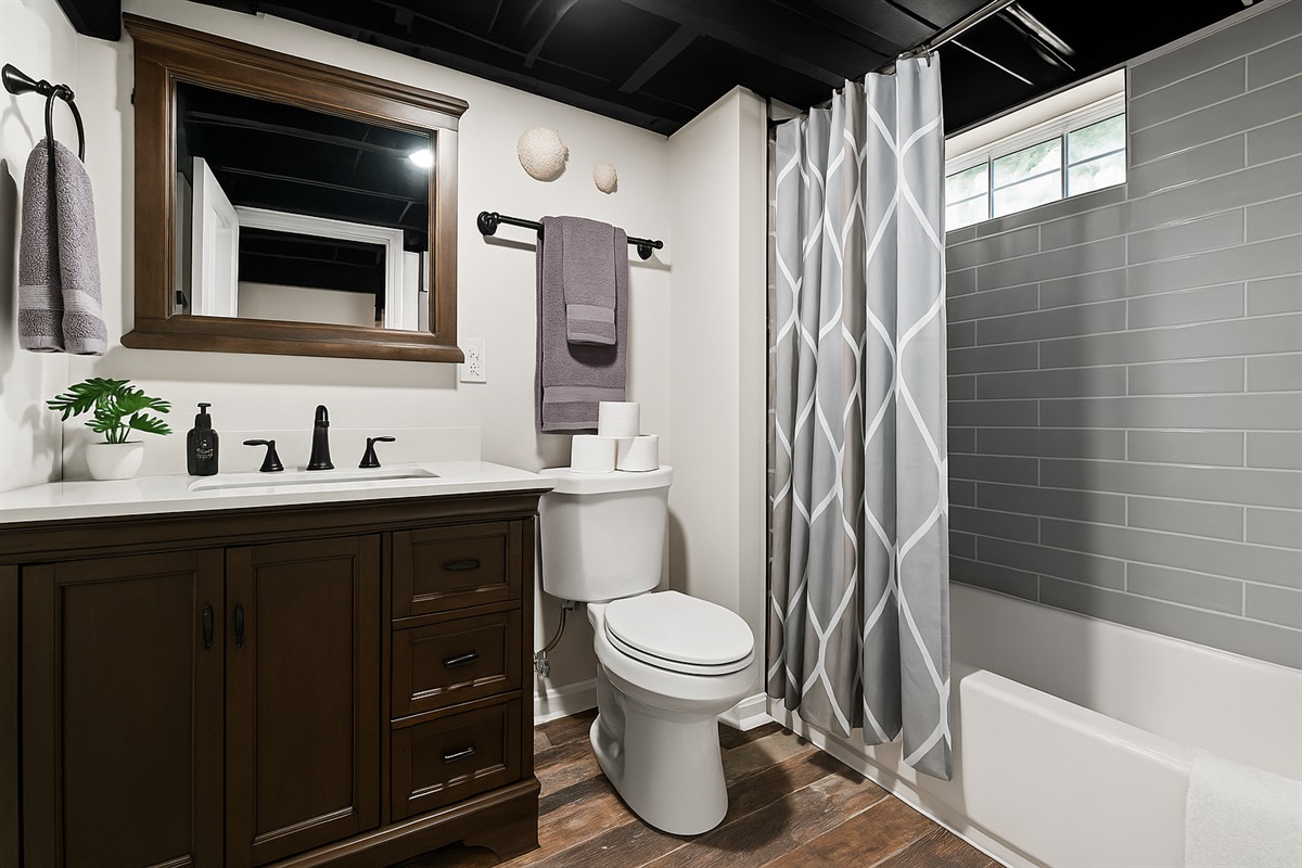 Stylish lower-level bathroom with modern finishes, full tub/shower combo, and all the essentials.