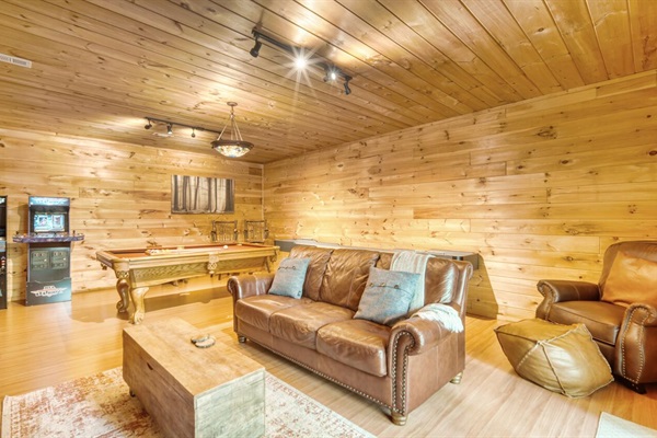 Game room with pool table, shuffle board, arcade games, and 50" smart tv