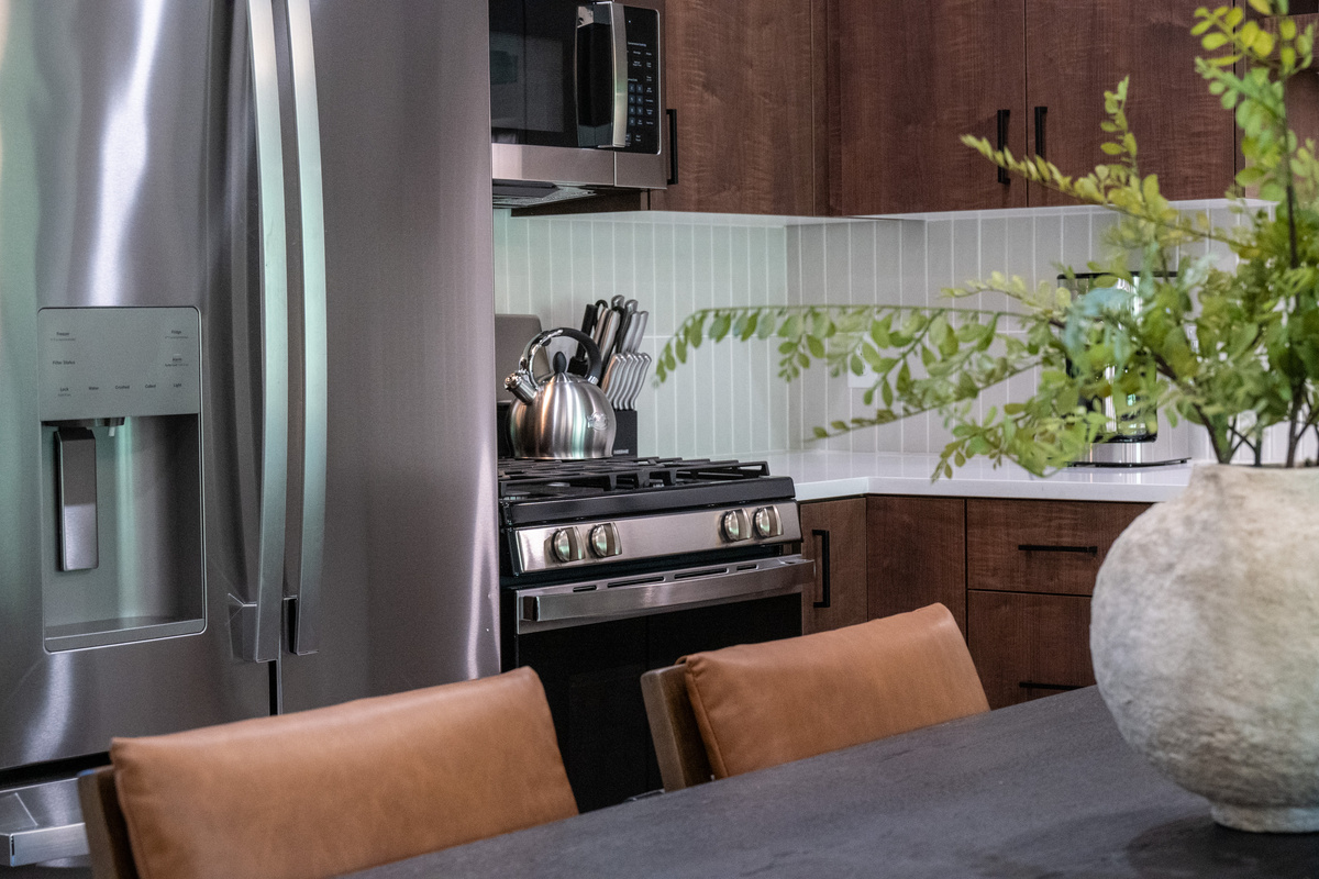 Well-appointed kitchen featuring a gas range and stainless steel refrigerator.