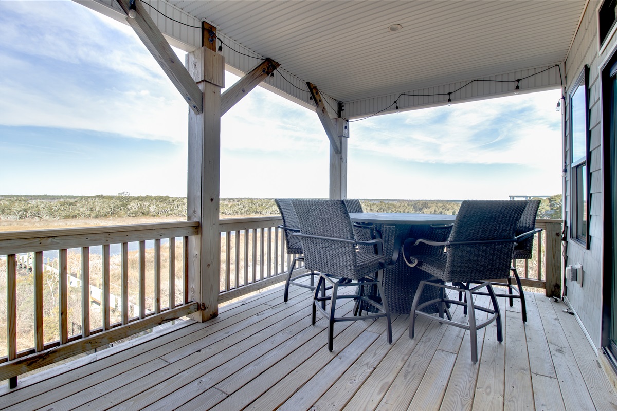 A spacious covered deck designed for gathering, relaxing, and soaking in the open air