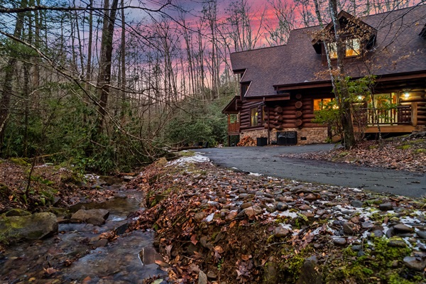 Twilight View of Cabin Nestled Along a Mountain Stream