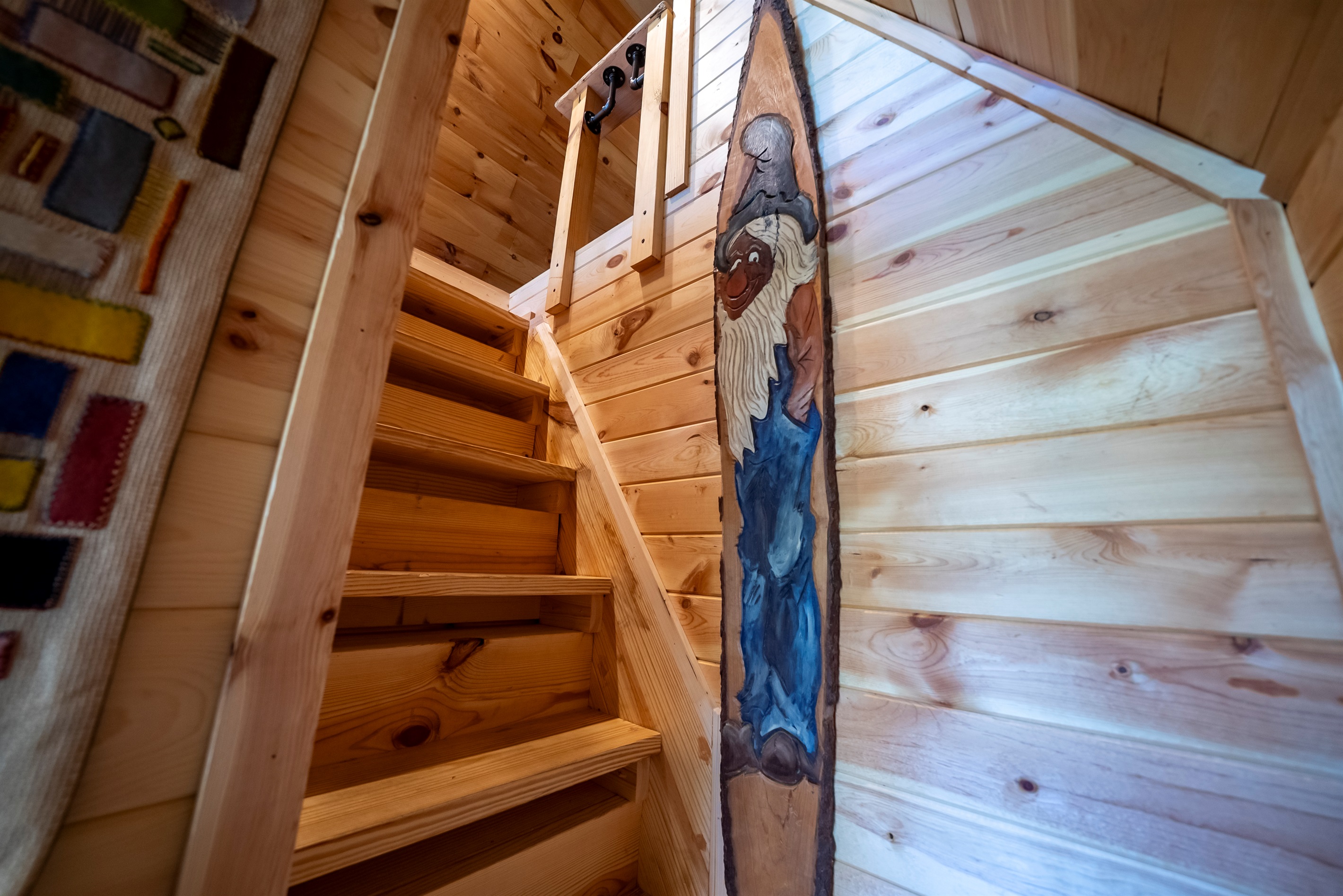 Follow the stairs up to the loft bedroom, where the classic A-frame design really shines.