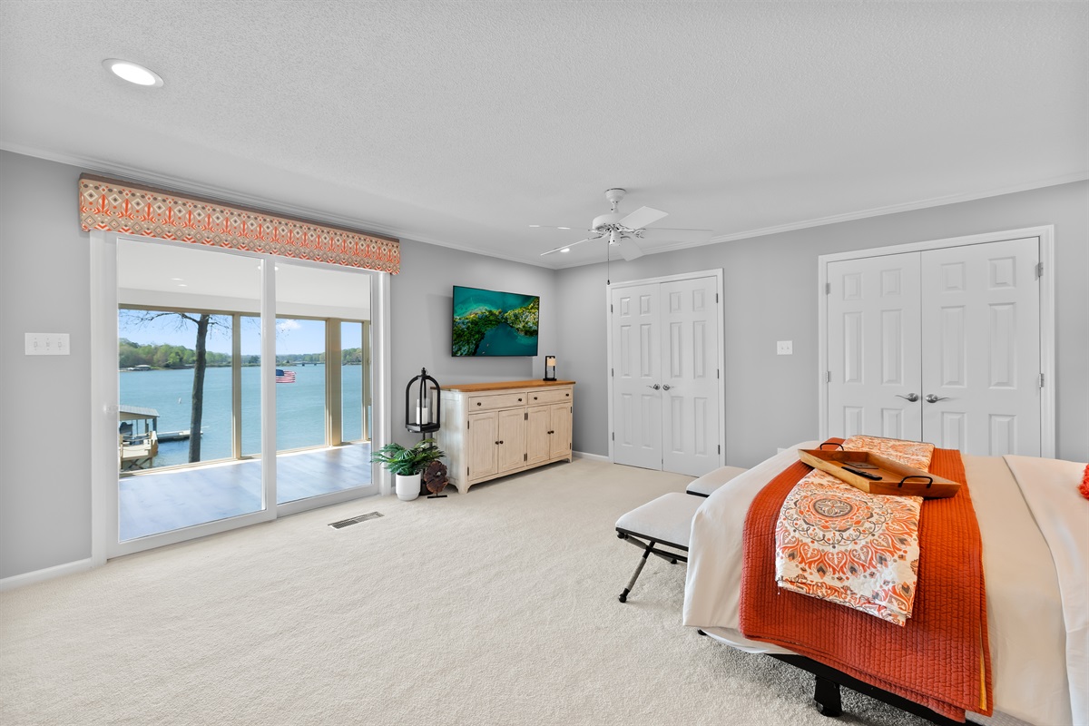 Spacious master bedroom with a king bed and peaceful views of Lake Norman. 