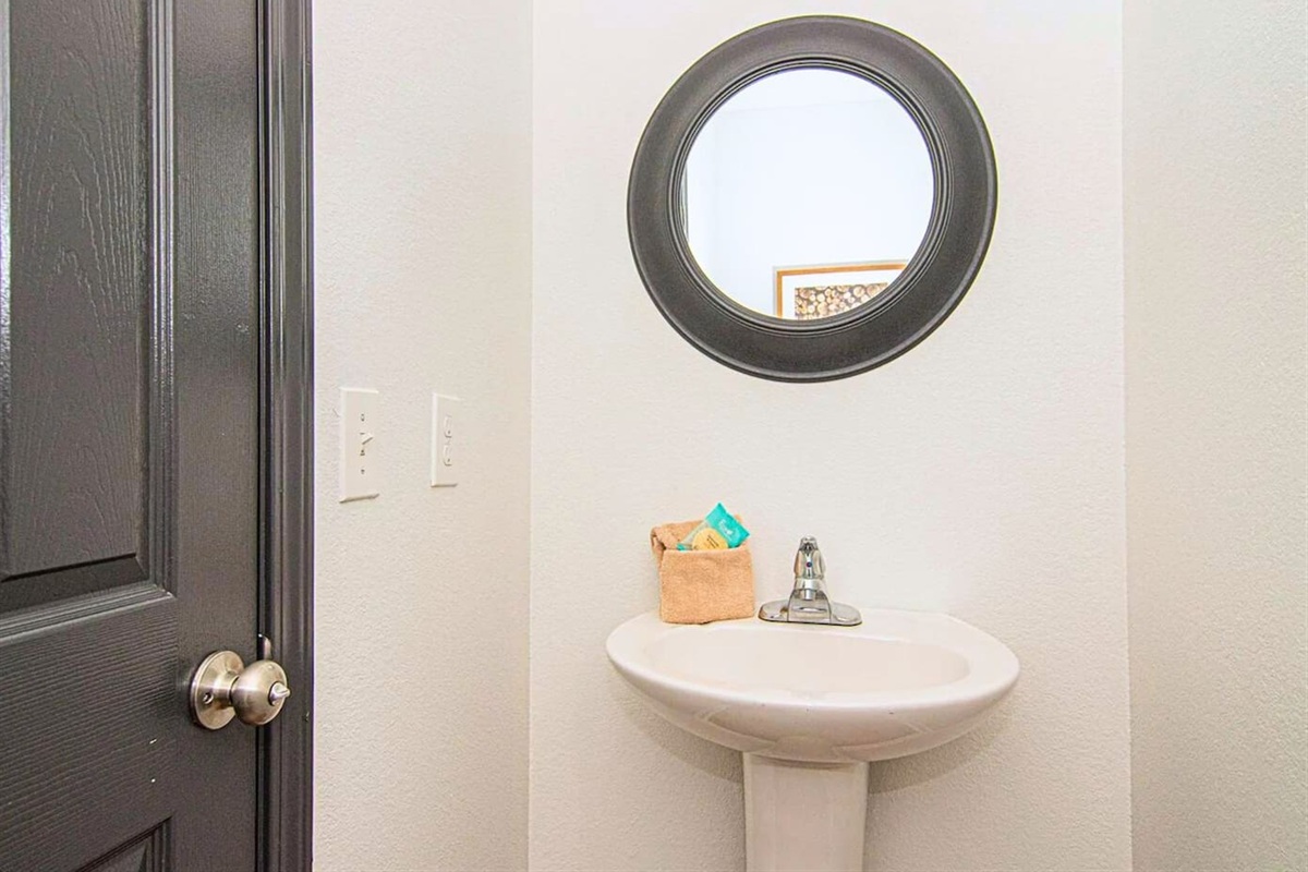 A simple yet elegant half bath with all the essentials offers convenience without compromising on style.