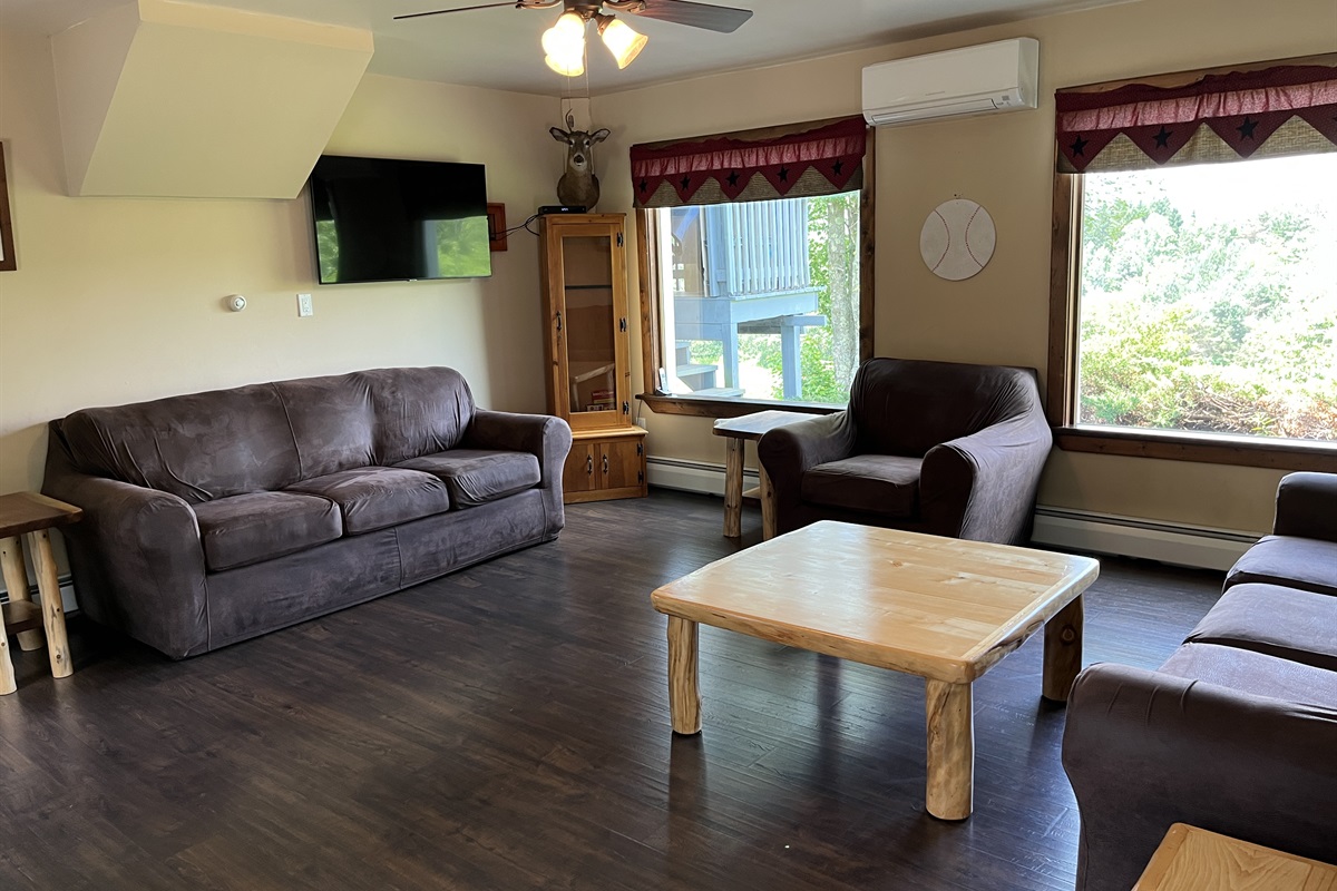 Living room with lots of comfy seating and a smart TV.