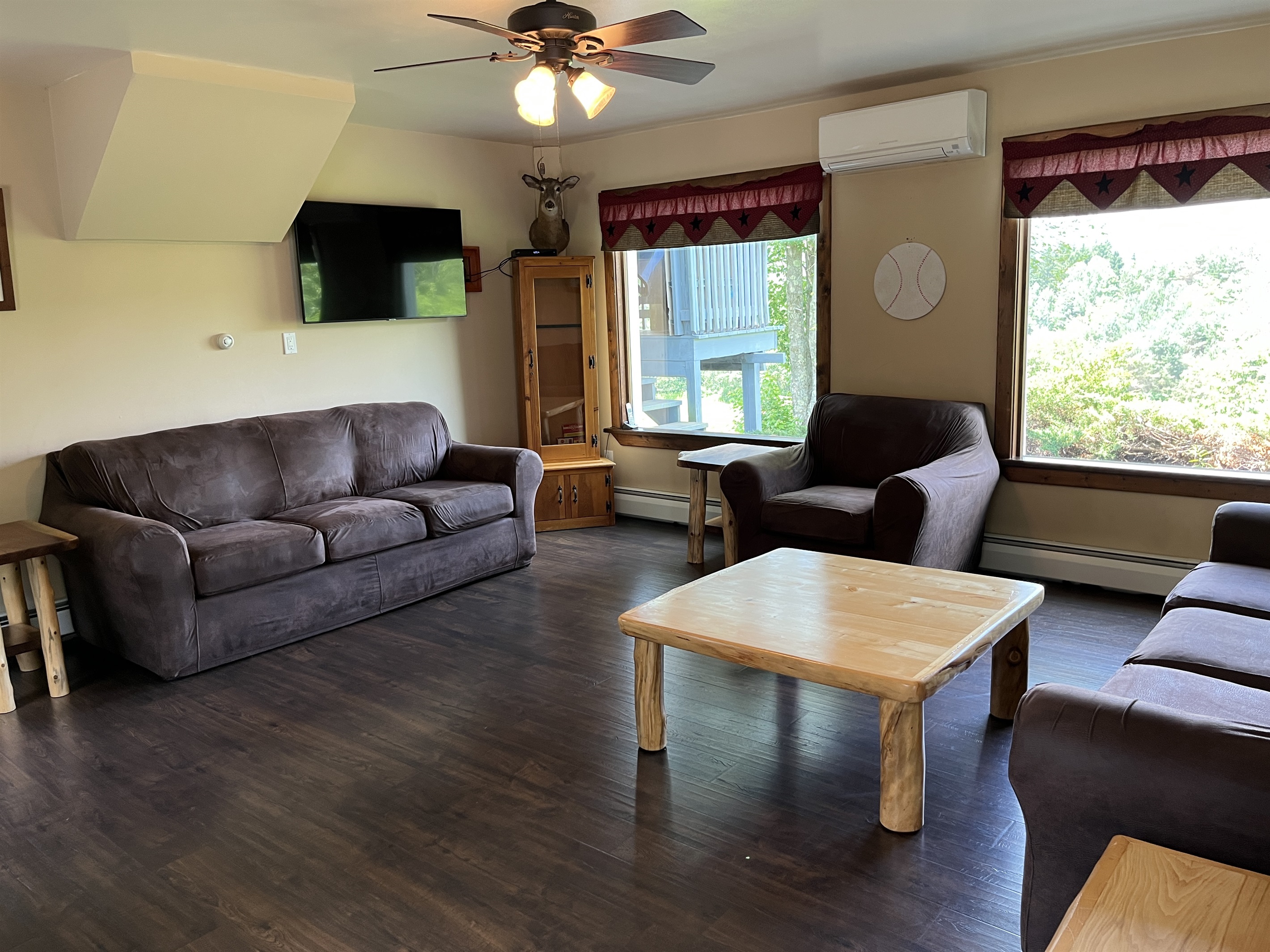 Living room with lots of comfy seating and a smart TV.