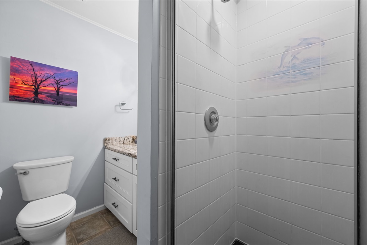Walk-in shower with crisp tile and subtle coastal details for a refreshing start or end to your day
