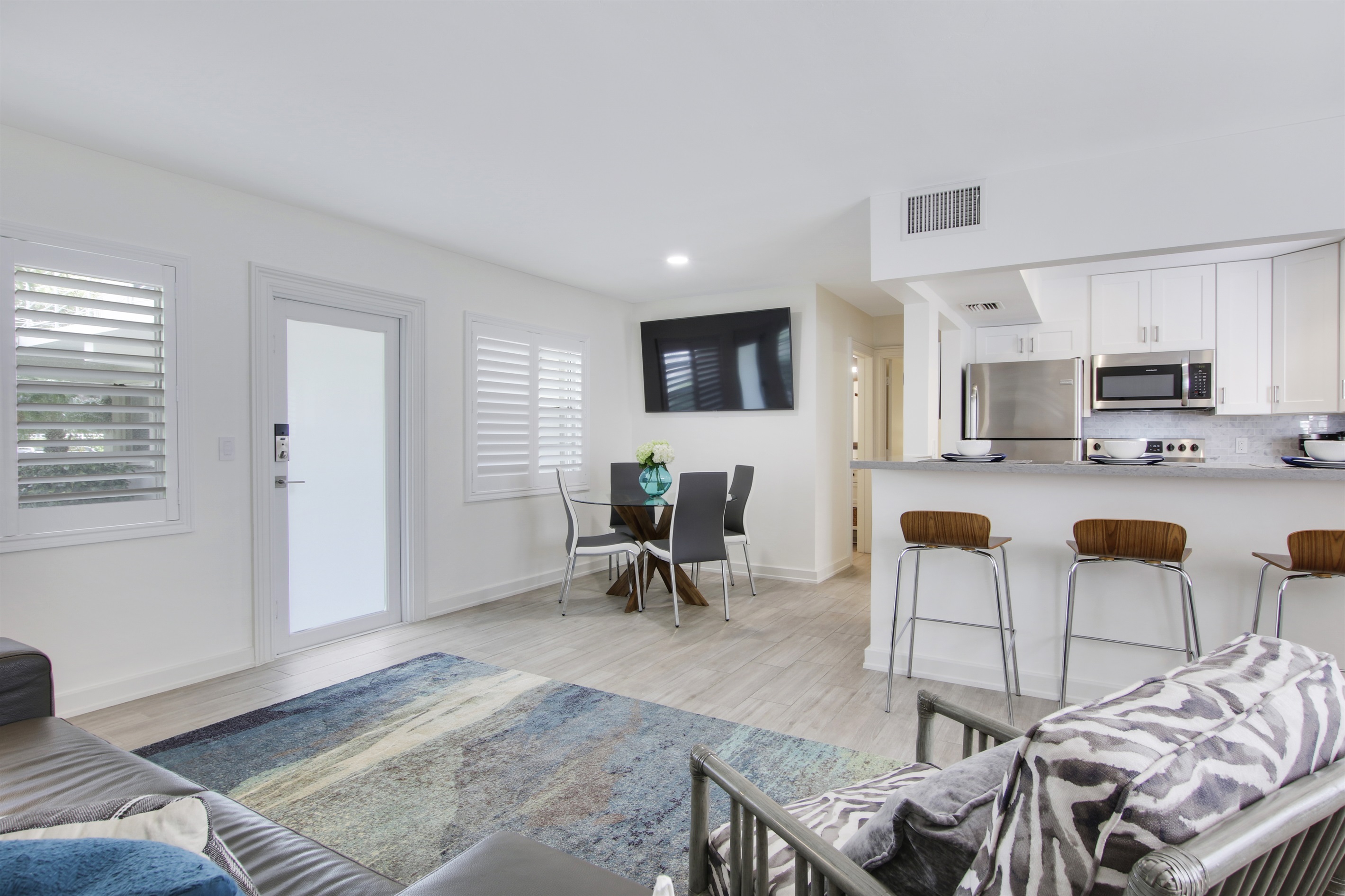 Flat screen TV, dining table and island seating