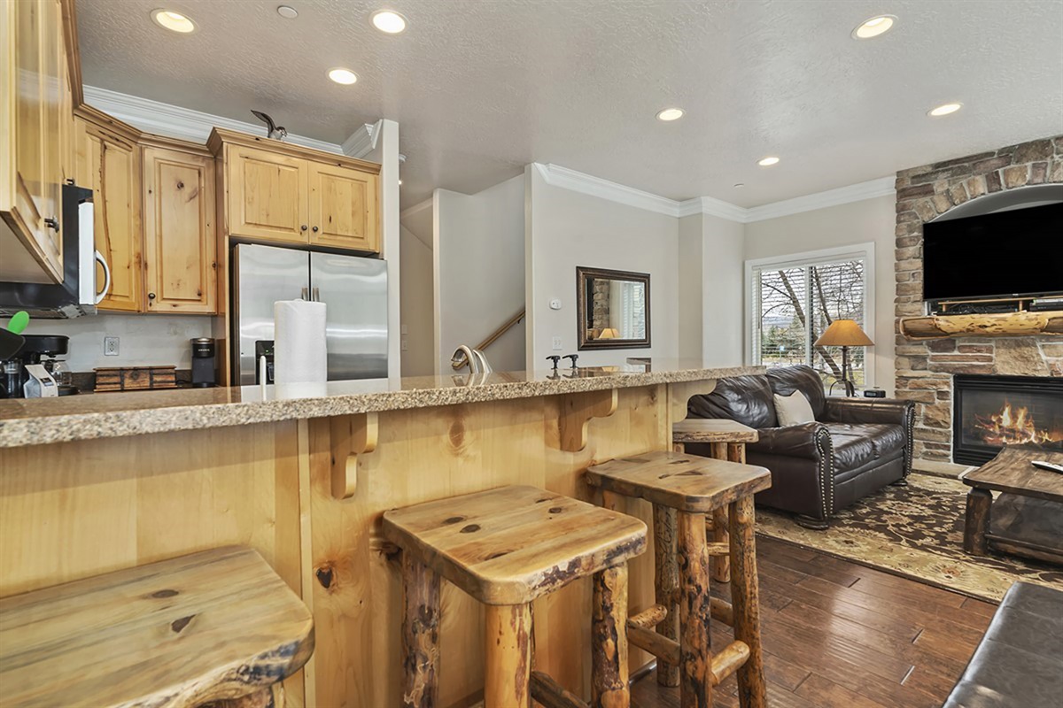 A welcoming breakfast bar with additional seating, ideal for casual dining, morning coffee, or gathering with guests.