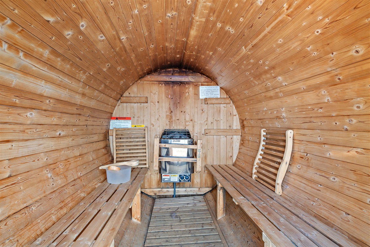 Lakeside barrel sauna offers forest views and peaceful waters.