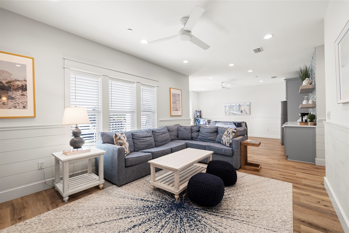 2nd floor living room has a comfortable sectional sofa with a smart tv