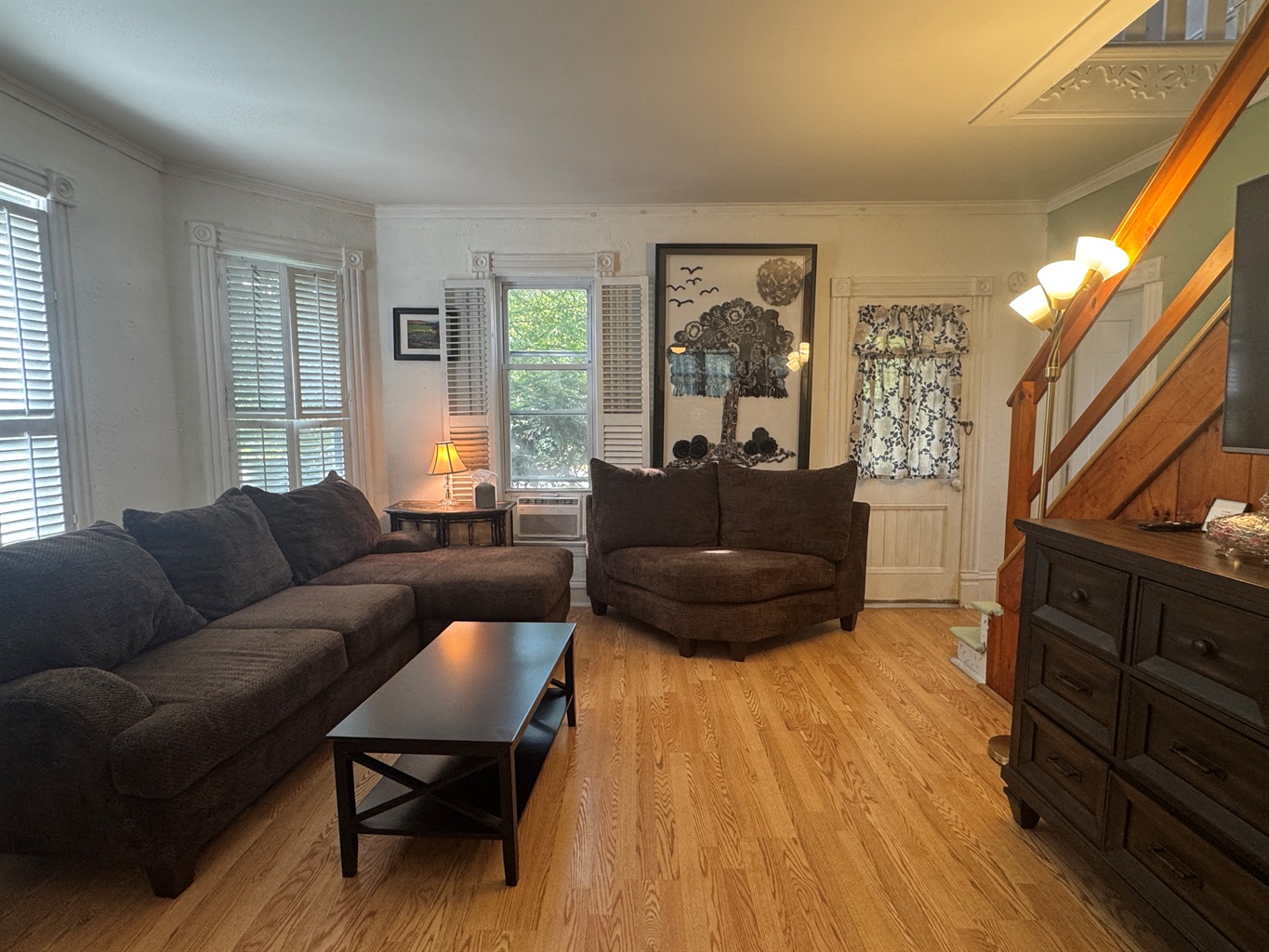 Main living room with comfy couches and large TV
