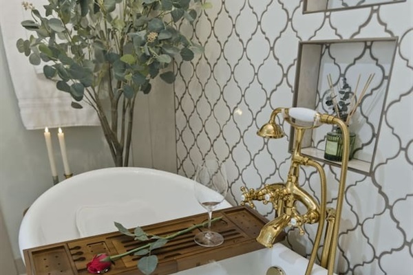Luxurious soaking tub with elegant gold fixtures for a spa-like experience