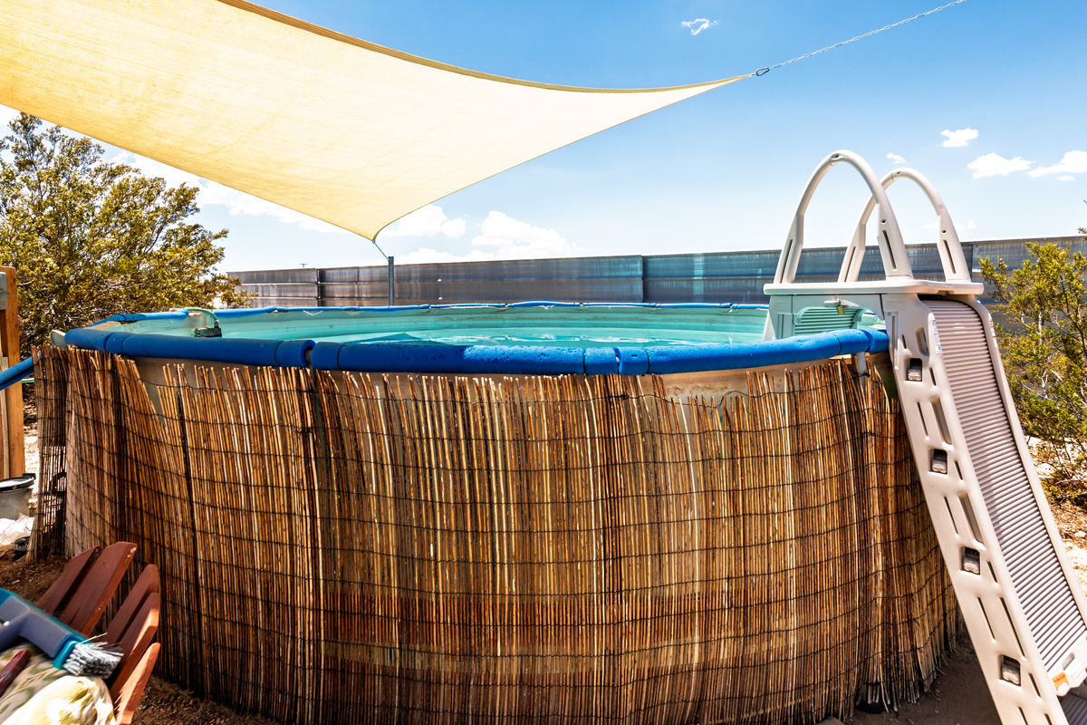 Spacious above ground pool with locking ladder. 