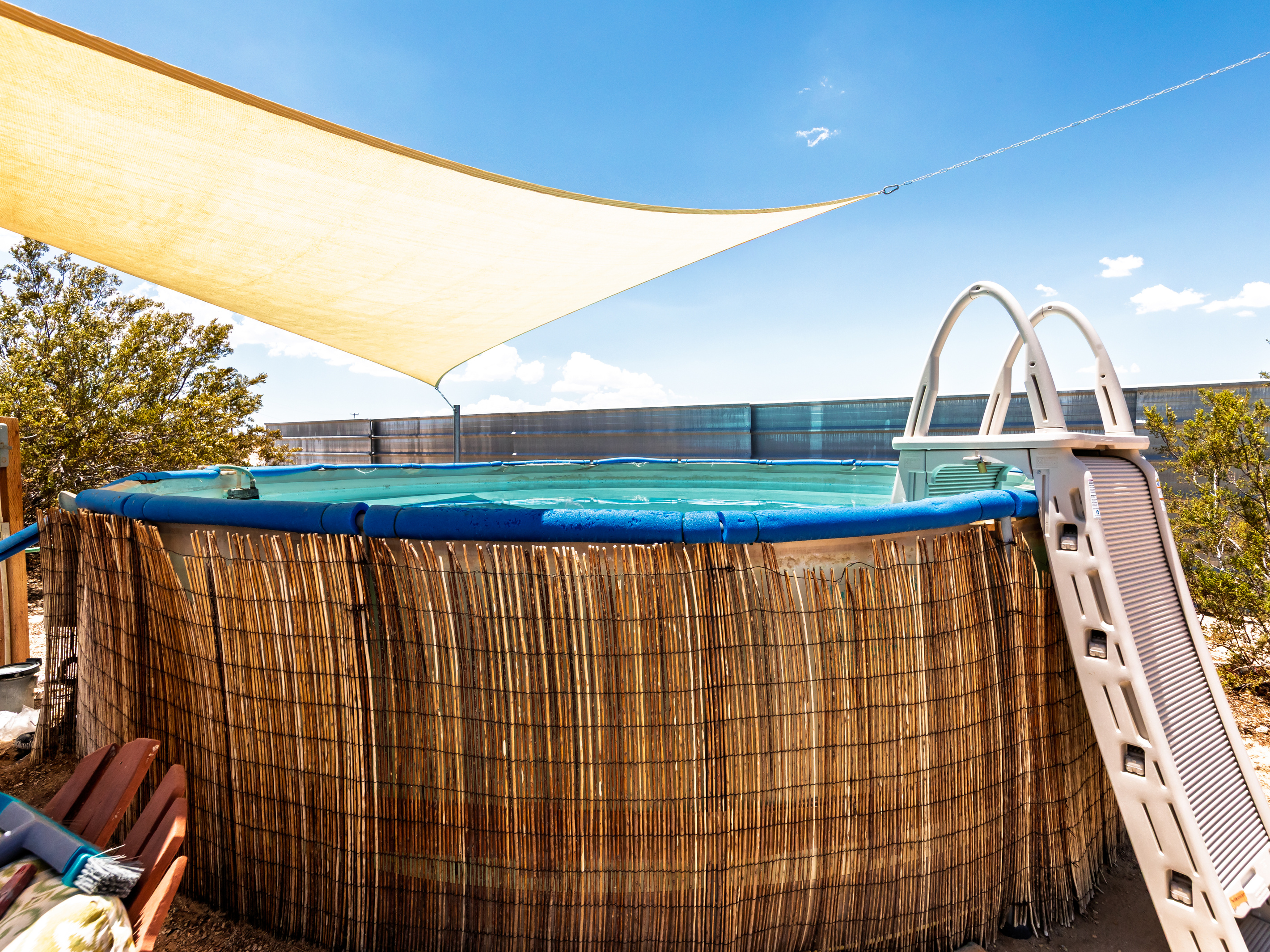 Spacious above ground pool with locking ladder. 