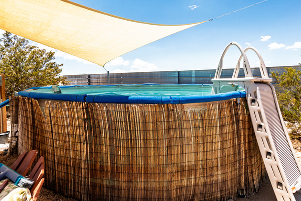 Spacious above ground pool with locking ladder. 
