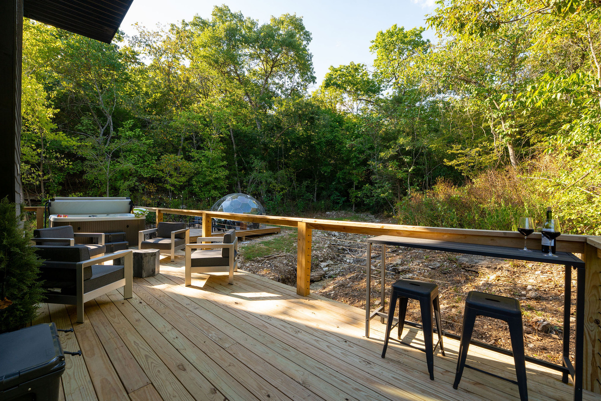 Slow down on the covered deck with forest views, lounge seating and space to dine outdoors.