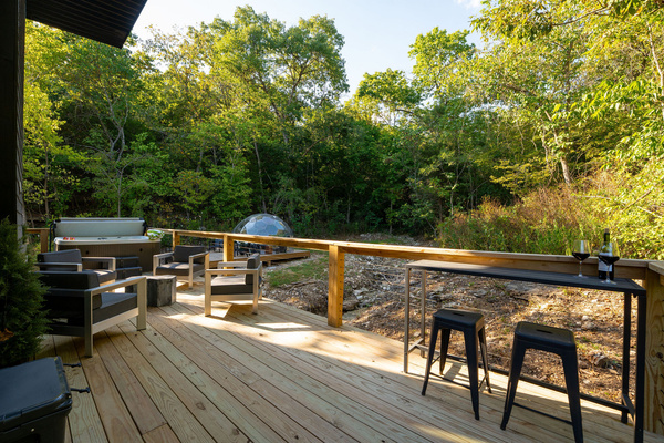 Slow down on the covered deck with forest views, lounge seating and space to dine outdoors.