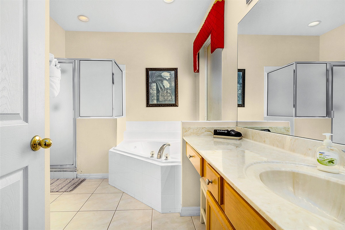 The king master bath features a garden tub and shower stall.