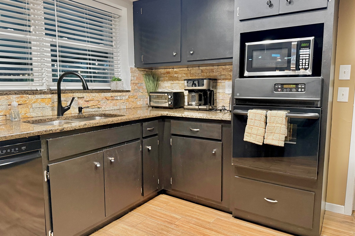 From a built-in oven to a microwave, toaster, coffee maker, and blender, this kitchen is stocked with all the essentials for cooking, baking, and snacking in comfort.