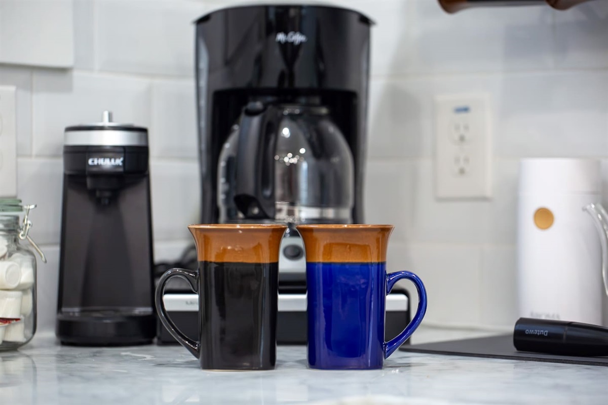 Indulge in the simple pleasure of a fresh cup in our chic kitchen, where the blend of modern design and homely touches creates the perfect brew spot.