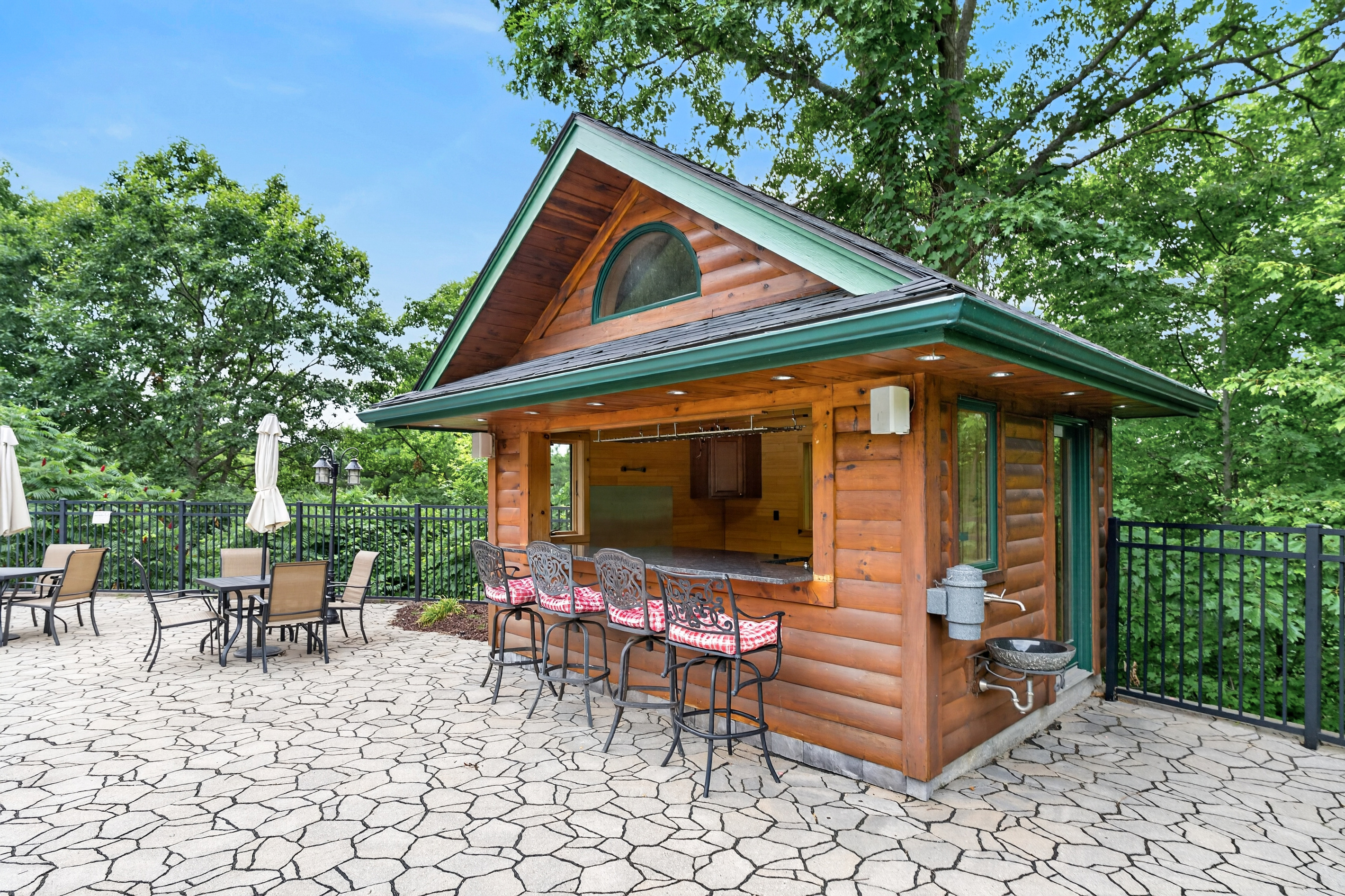 Poolside seating beside the wooden tiki bar