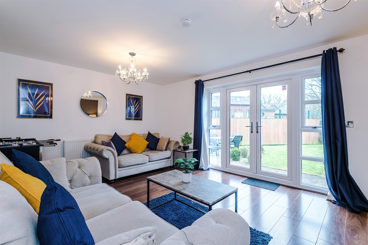The spacious, bright and vibrant lounge benefits from a comfortable atmosphere and decor leading to the large rear garden via the French doors