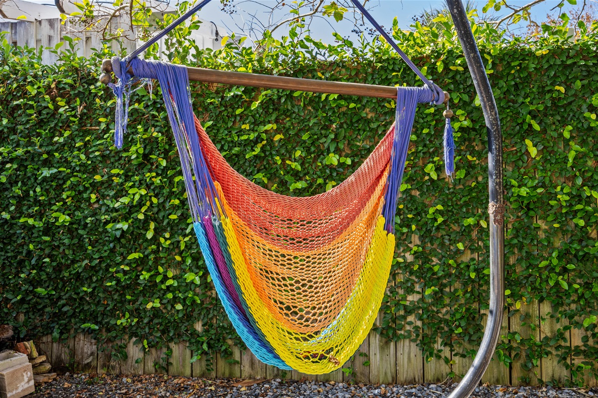 Colorful Hammock Chair
A rainbow‑woven hammock chair hangs beneath lush greenery, offering a cheerful and relaxing corner of the yard. Perfect for reading, napping, or simply unwinding.