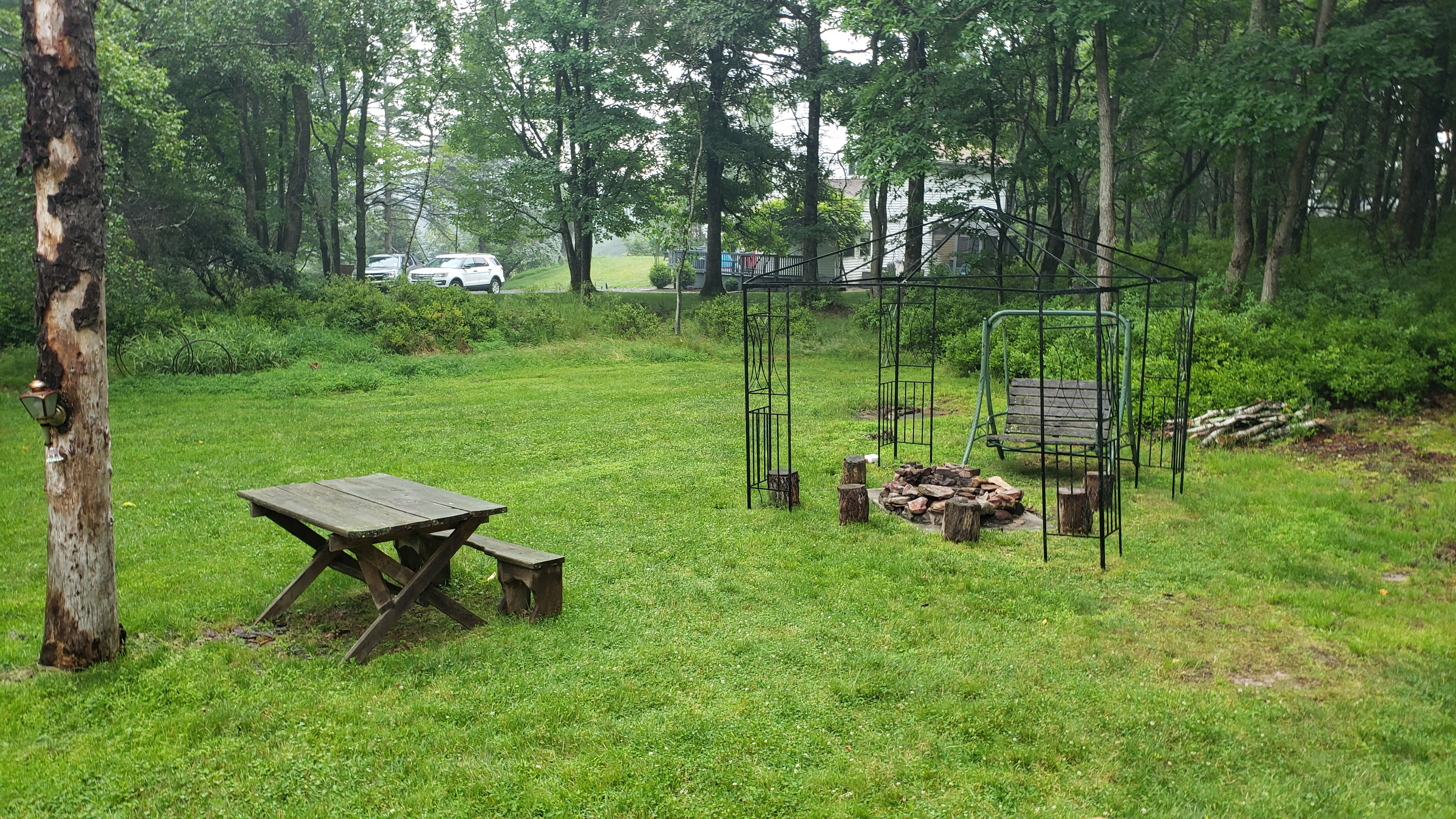 Large backyard with cozy firepit area.