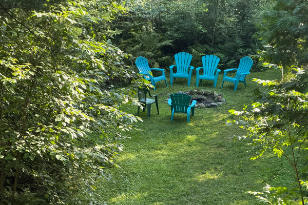Seating around fire pit close to lake's edge
