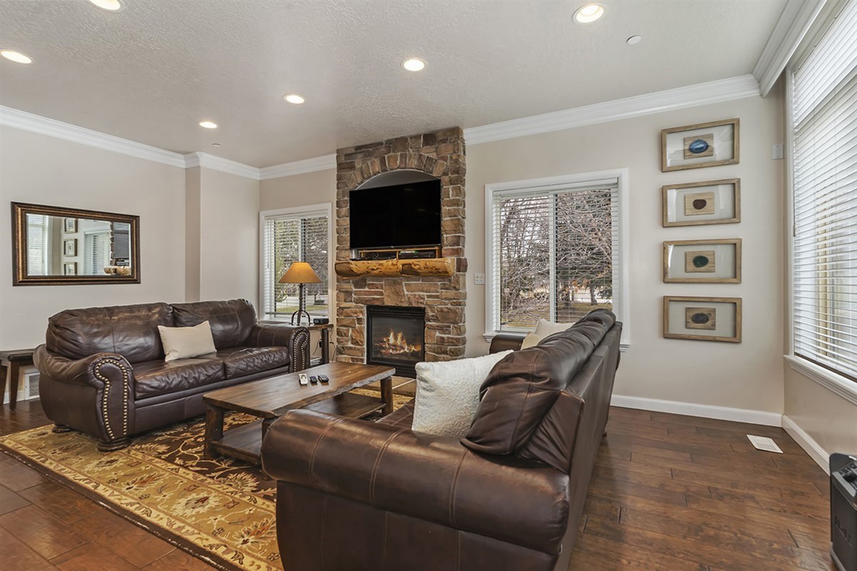 A warm and inviting gathering space featuring a cozy gas fireplace, rich textures, and refined finishes—ideal for unwinding or entertaining in style.