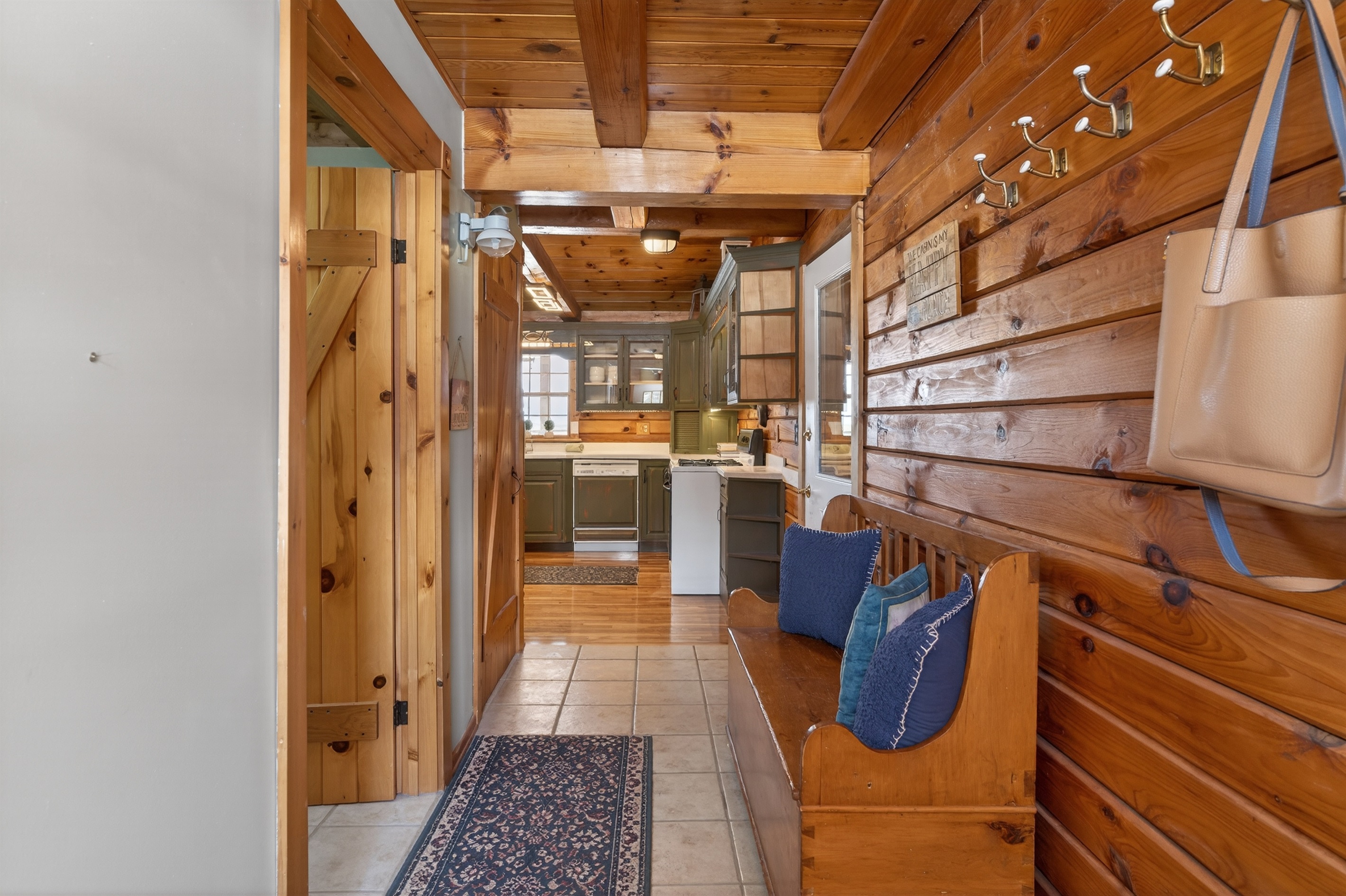 Entry hallway with laundry room and half bath