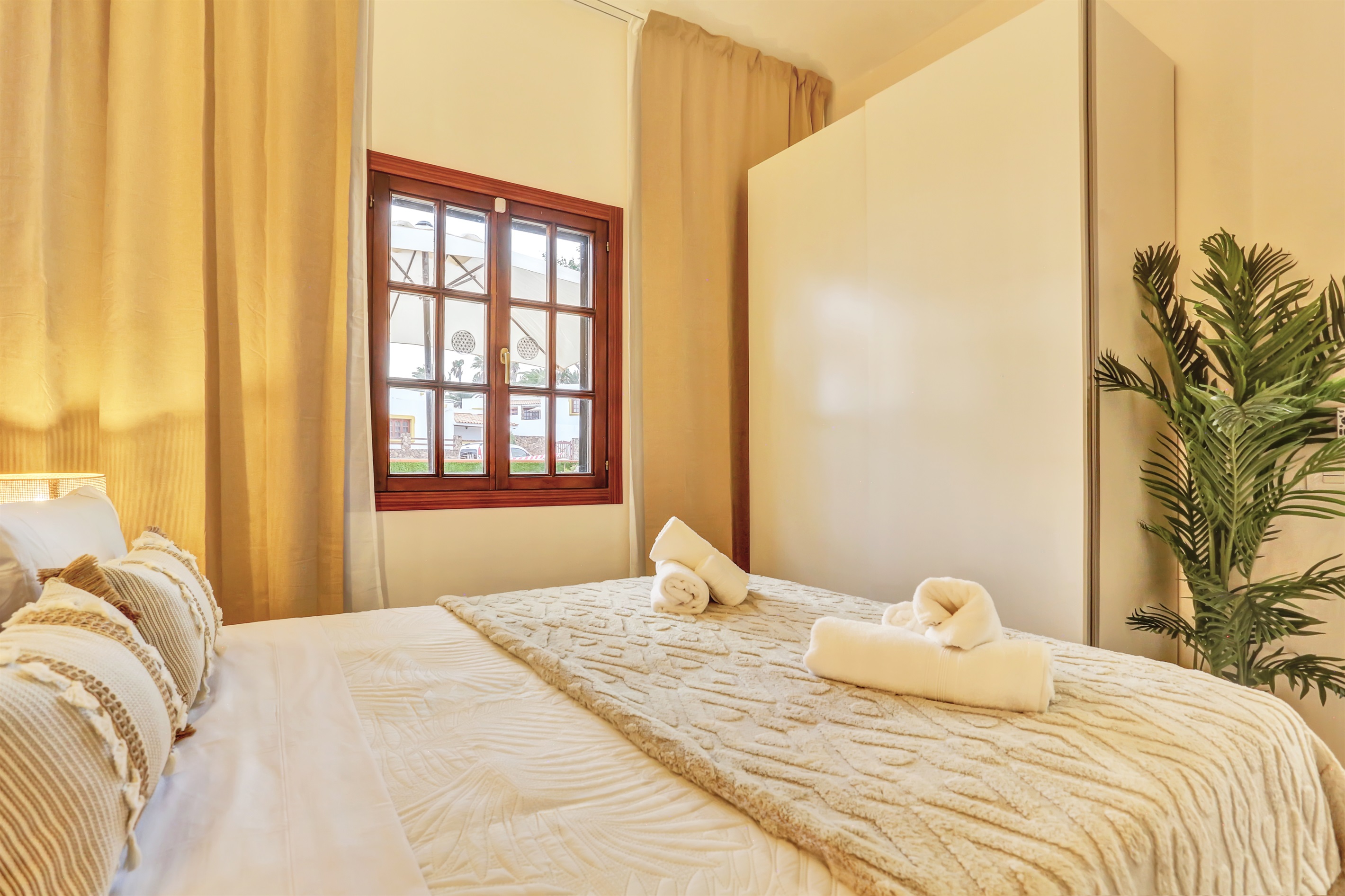 Bright master bedroom with a double bed, spacious wardrobes, and plenty of natural light.