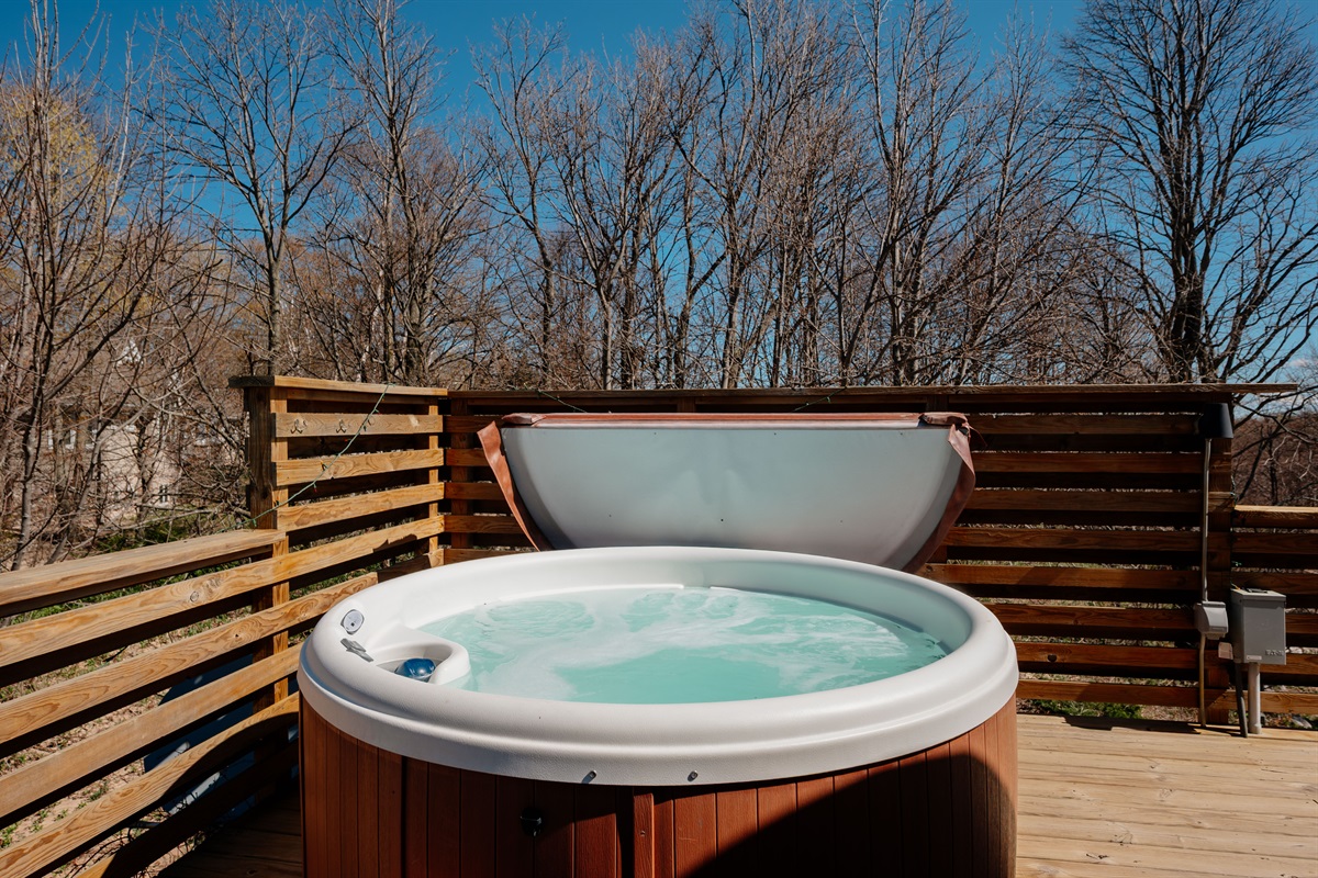 Unwind in the private hot tub surrounded by peaceful wooded views after a day exploring the dunes and Lake Michigan shoreline.