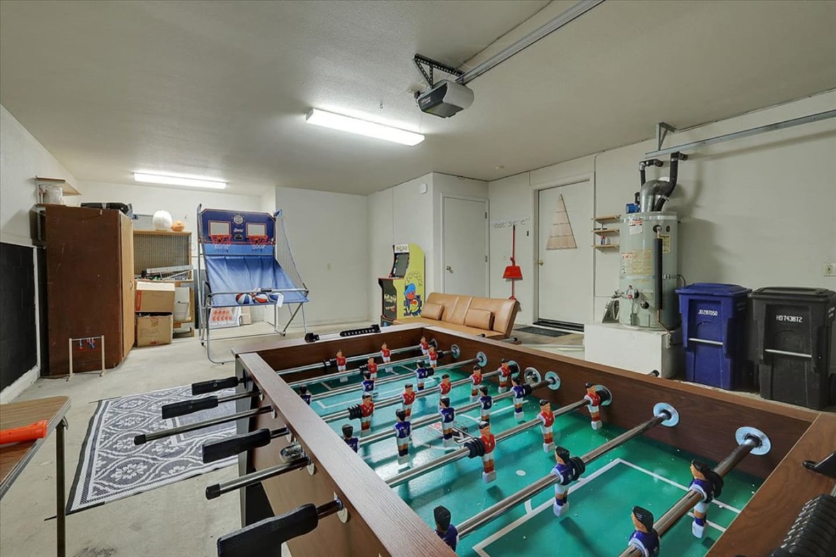 Game room with foosball, arcade games, and space for easy indoor fun.
