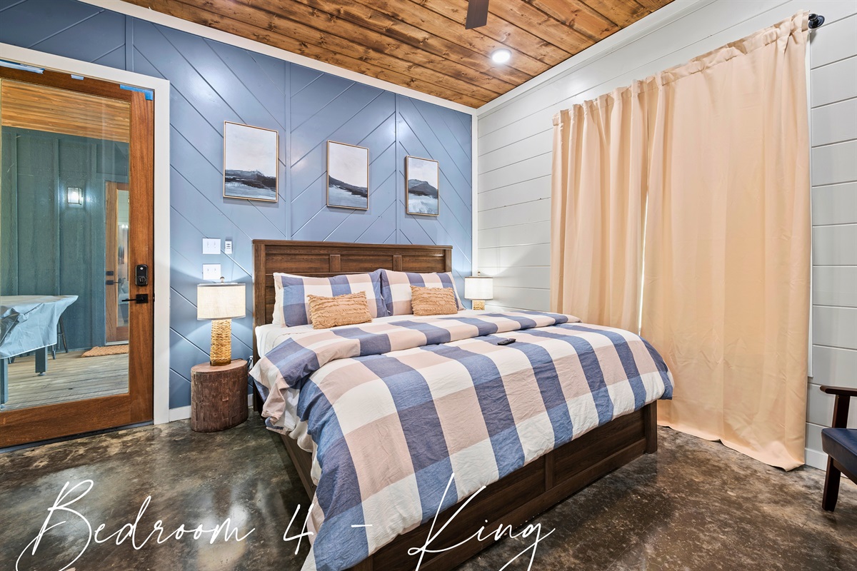 Unwind in the small house bedroom where a stately king bed awaits to envelop you in a restful night's sleep.