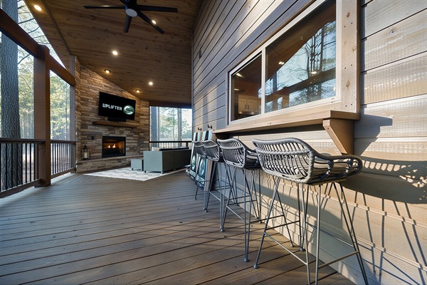 Outdoor bar seating with kitchen pass-through window for easy indoor-to-outdoor serving.