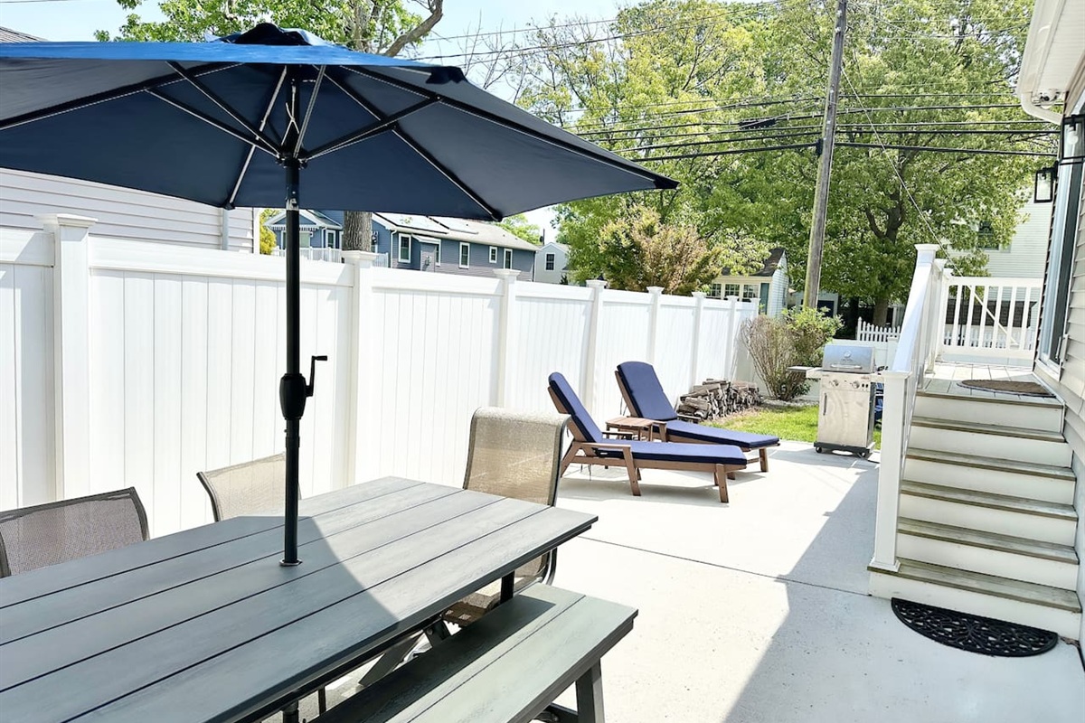 Fire up the grill for a summer BBQ on this private, fenced-in patio. Whether dining under the shaded umbrella or lounging in the sun, this outdoor space is built for slow afternoons and fresh air.