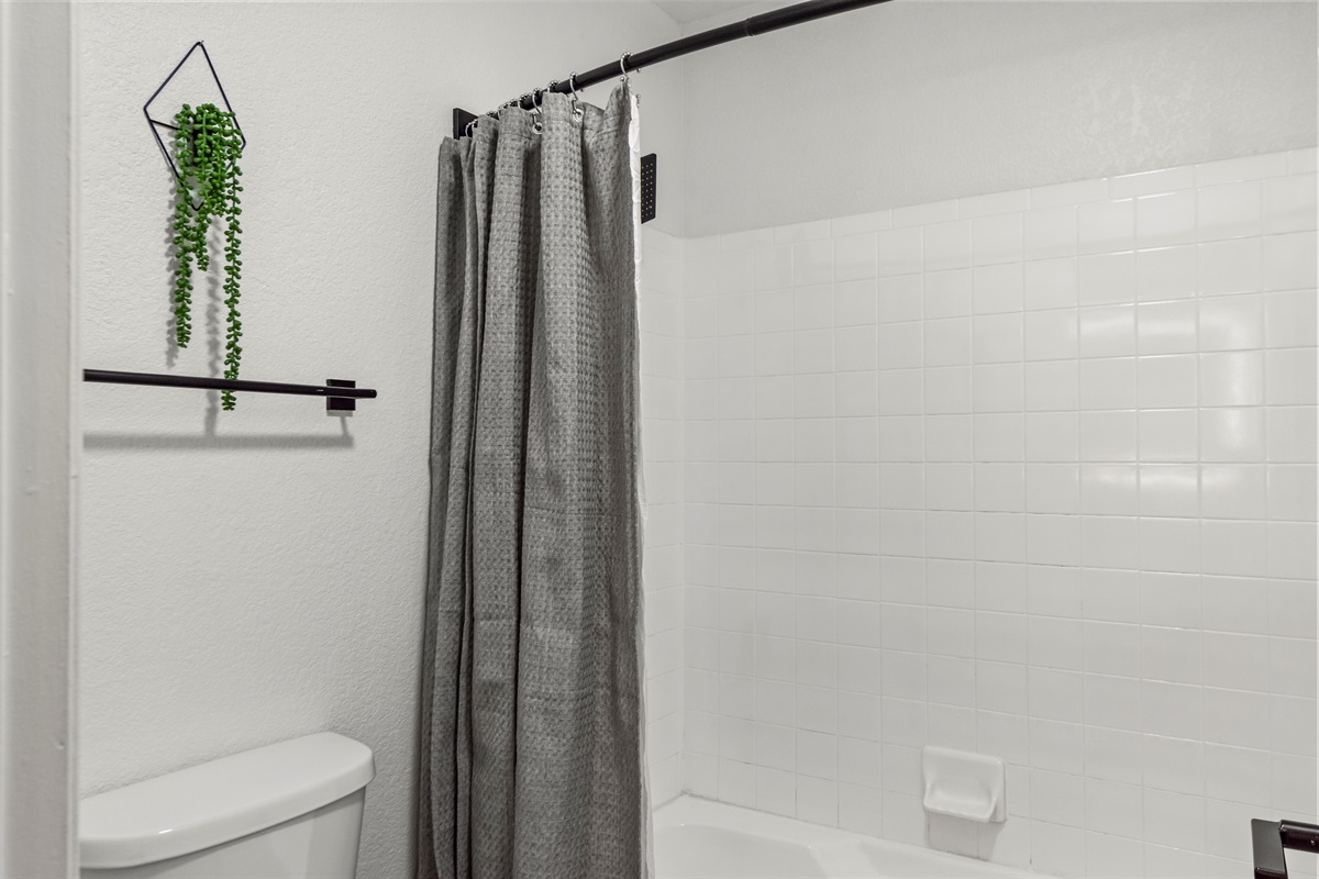 Bright and spotless bathroom stocked with fresh towels and essential toiletries for a comfortable stay.