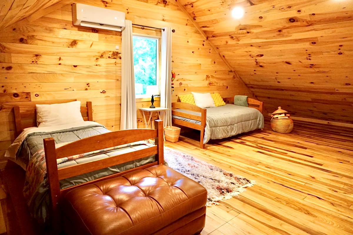 Attic Retreat: Bright wood accents and comfy beds create the perfect mountain getaway!