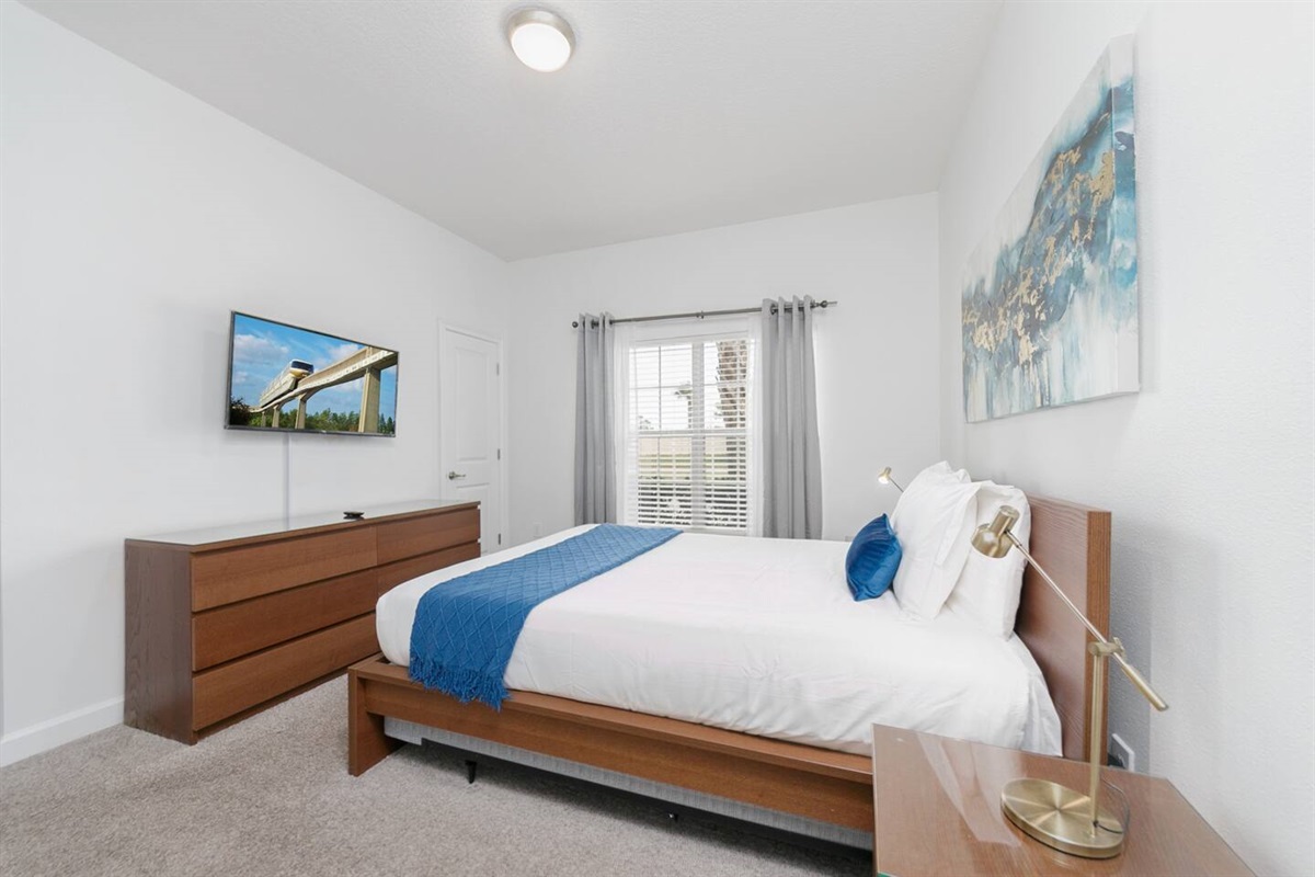 This is the bedroom downstairs, with a queen bed and it's own TV