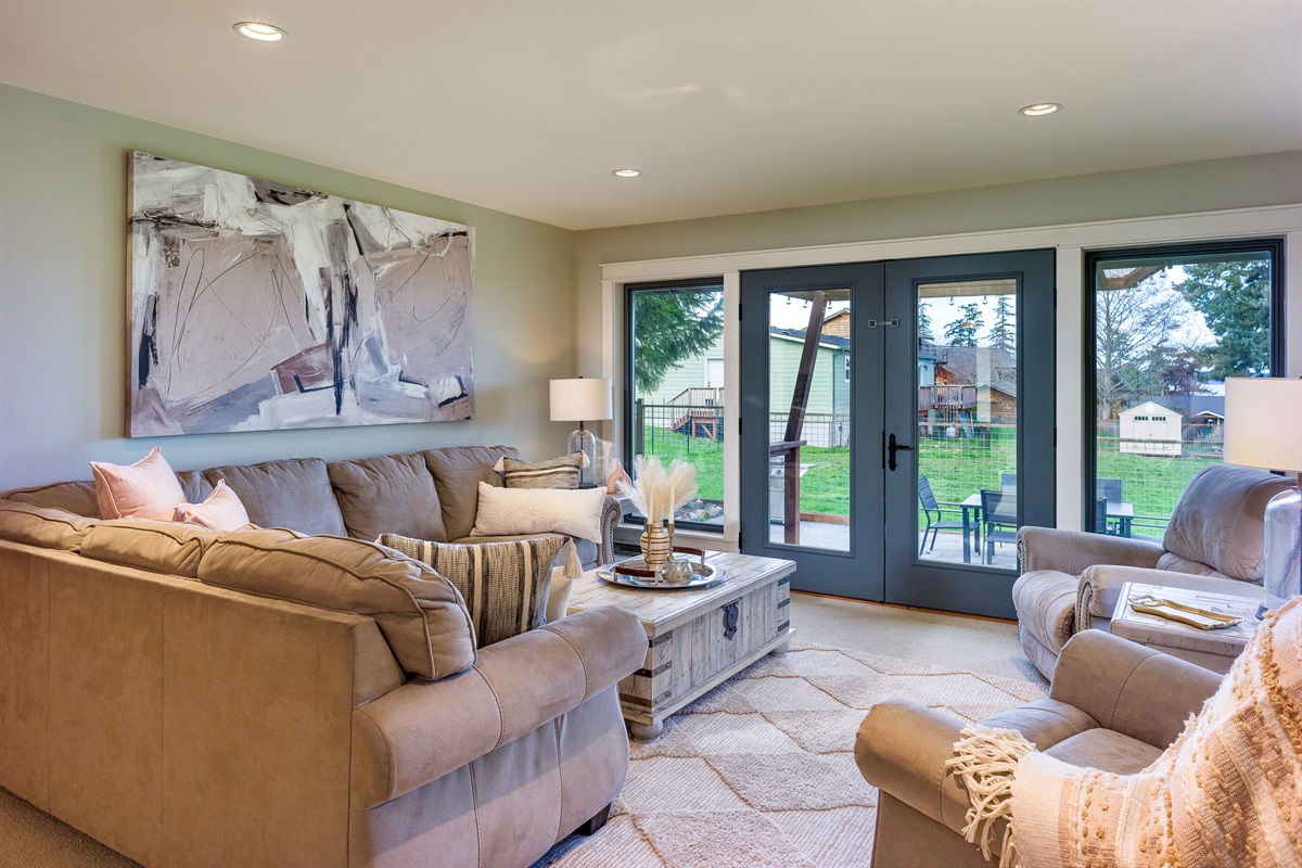 Straight out of this absolutely cozy living room you can enter on to the patio. The living room has peek-a-boo views of the water that awaits you.