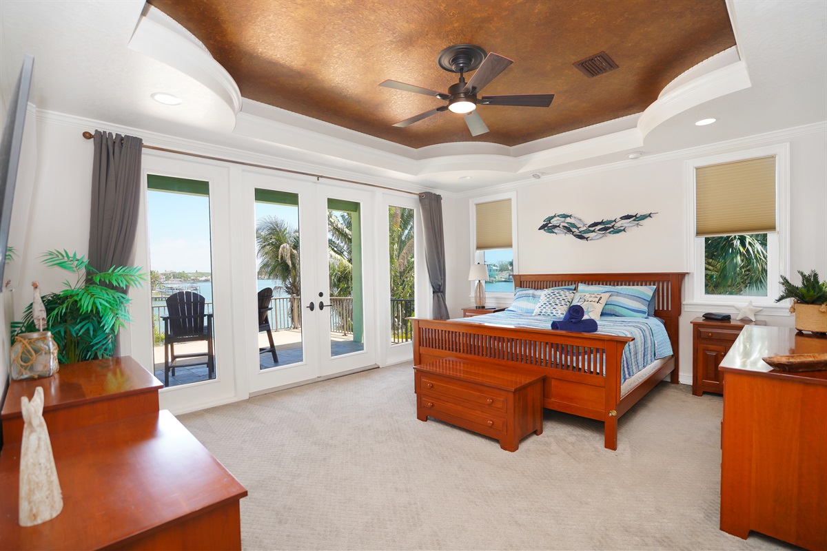 Master bedroom offers stunning water views and balcony.