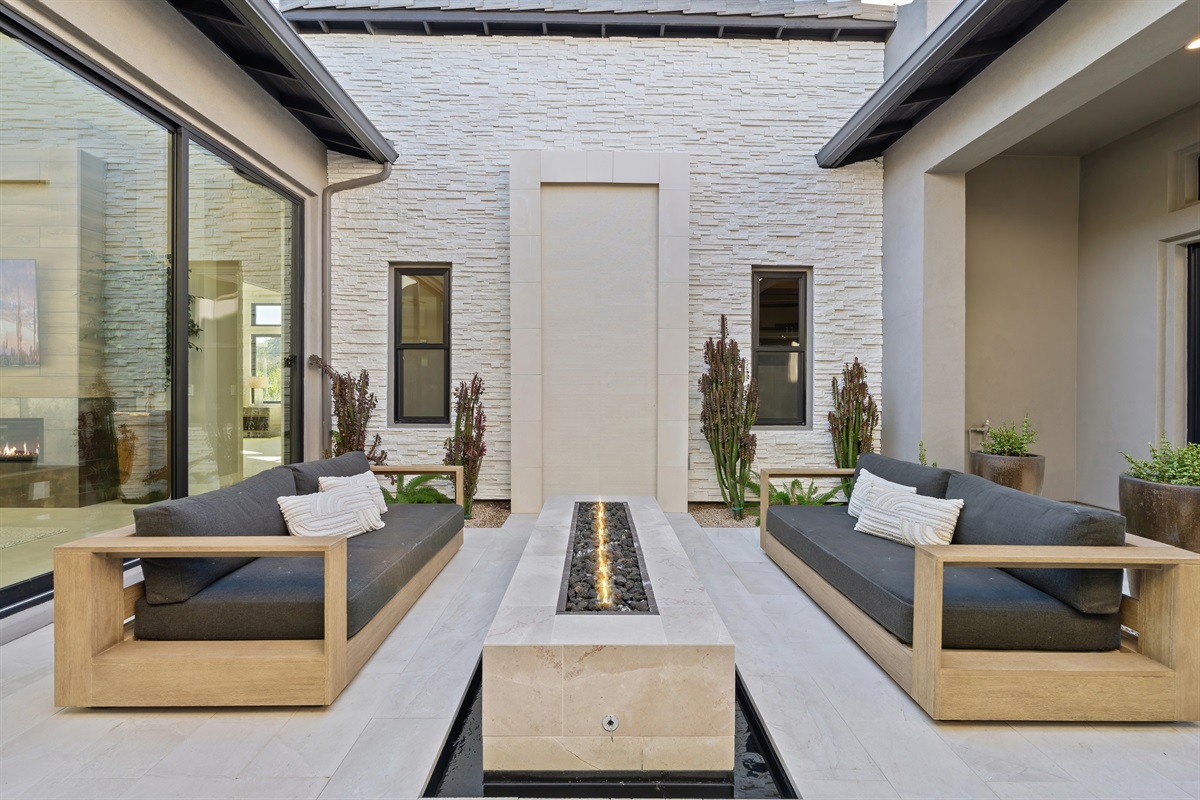 High End luxury includes this stunning stone fire table to gather and enjoy.  a