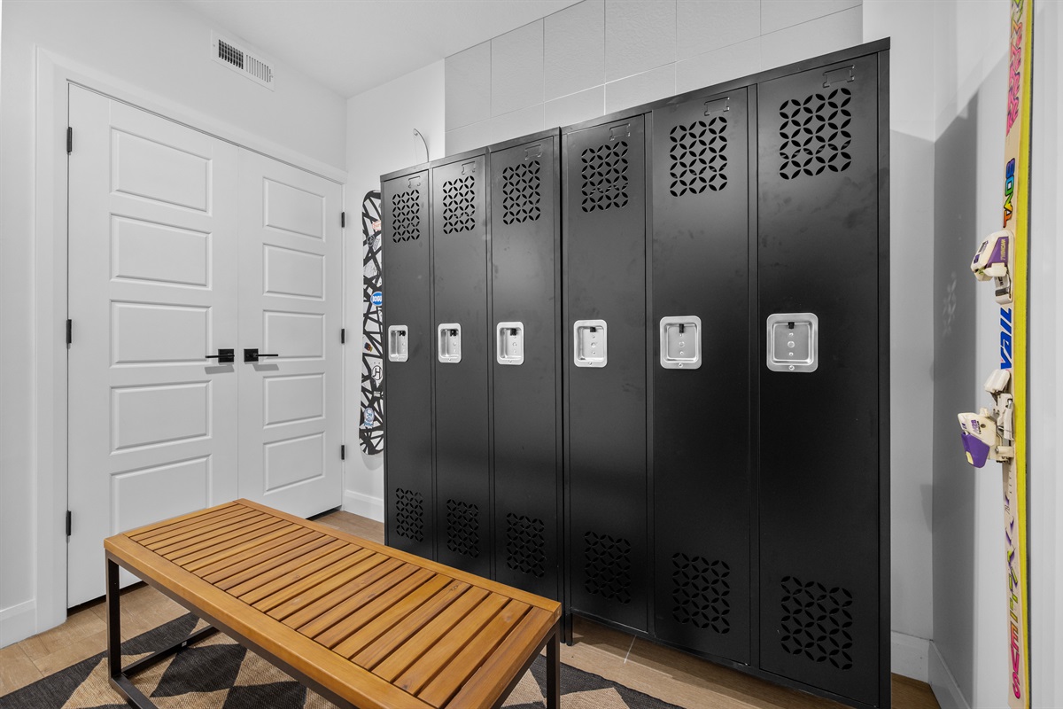 Locker room with six gear lockers, benches, and coat storage.