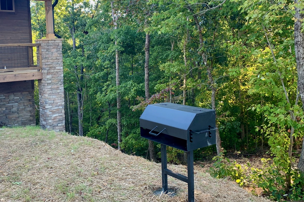 Charcoal grill along with grill utensils. 